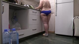 BBW MILF housewife in the kitchen wearing only panties. - 1 image