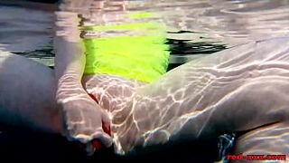 Red XXX fucks her pussy with a toy in the pool